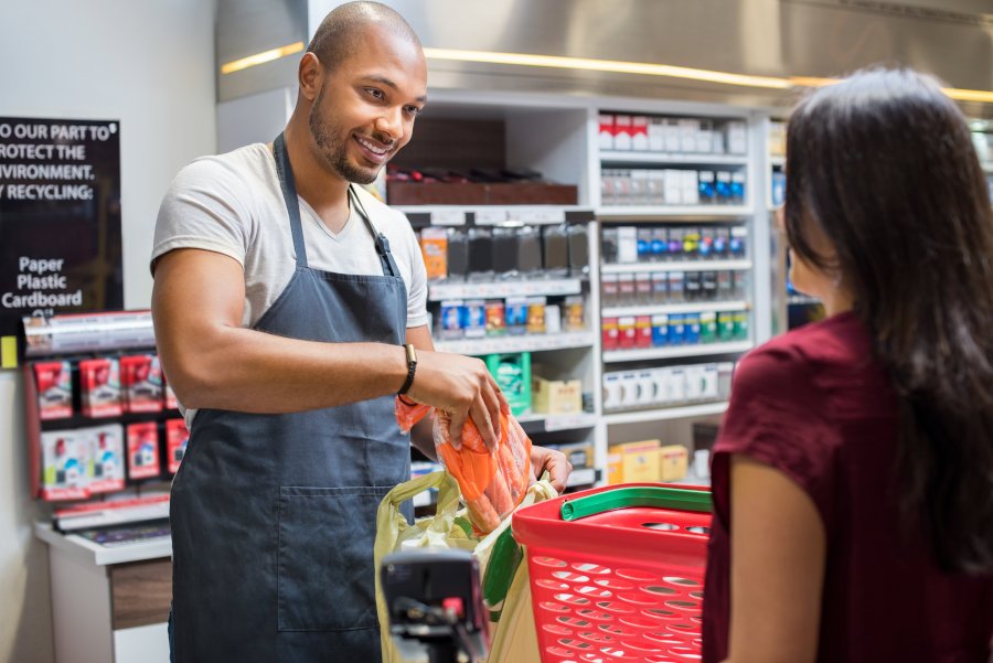 Cashier helping customer at point of sale