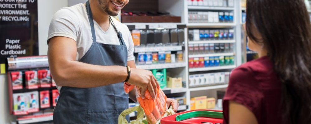 Cashier helping customer at point of sale